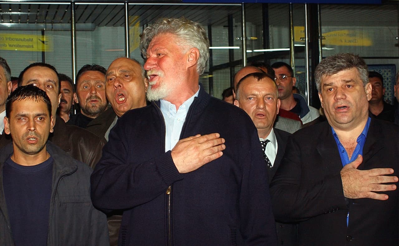 En 2004, el general Slobodan Praljak y otros comandantes se entregaron voluntariamente al tribunal de la ONU. En la fotografía, Praljak canta el himno nacional croata rodeado de amigos y seguidores antes de viajar a La Haya, donde sería juzgado.