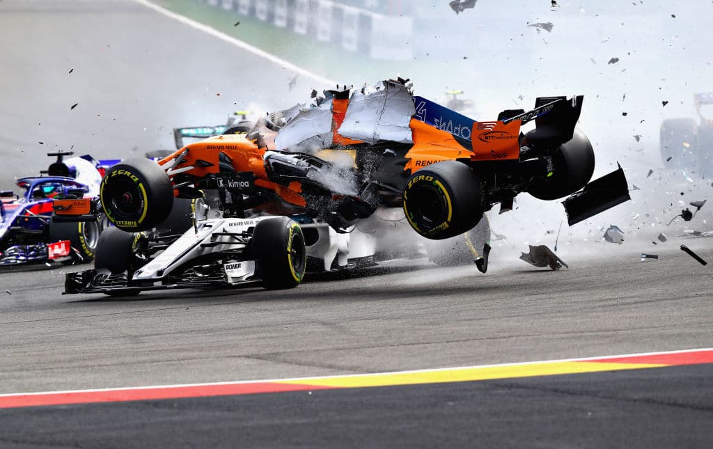 SPA, BELGIUM - AUGUST 26: Fernando Alonso of Spain driving the (14) McLaren F1 Team MCL33 Renault launches over the top of Charles Leclerc of Monaco driving the (16) Alfa Romeo Sauber F1 Team C37 Ferrari at the start during the Formula One Grand Prix of Belgium at Circuit de Spa-Francorchamps on August 26, 2018 in Spa, Belgium. (Photo by Mark Thompson/Getty Images)