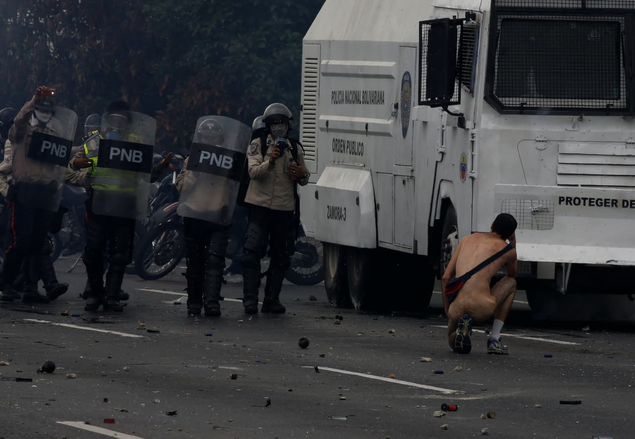 "They showered him with tear gas, but he kept walking," AFP photographer Juan Barreto told Univision. (Carlos García Rawlins/Reuters)