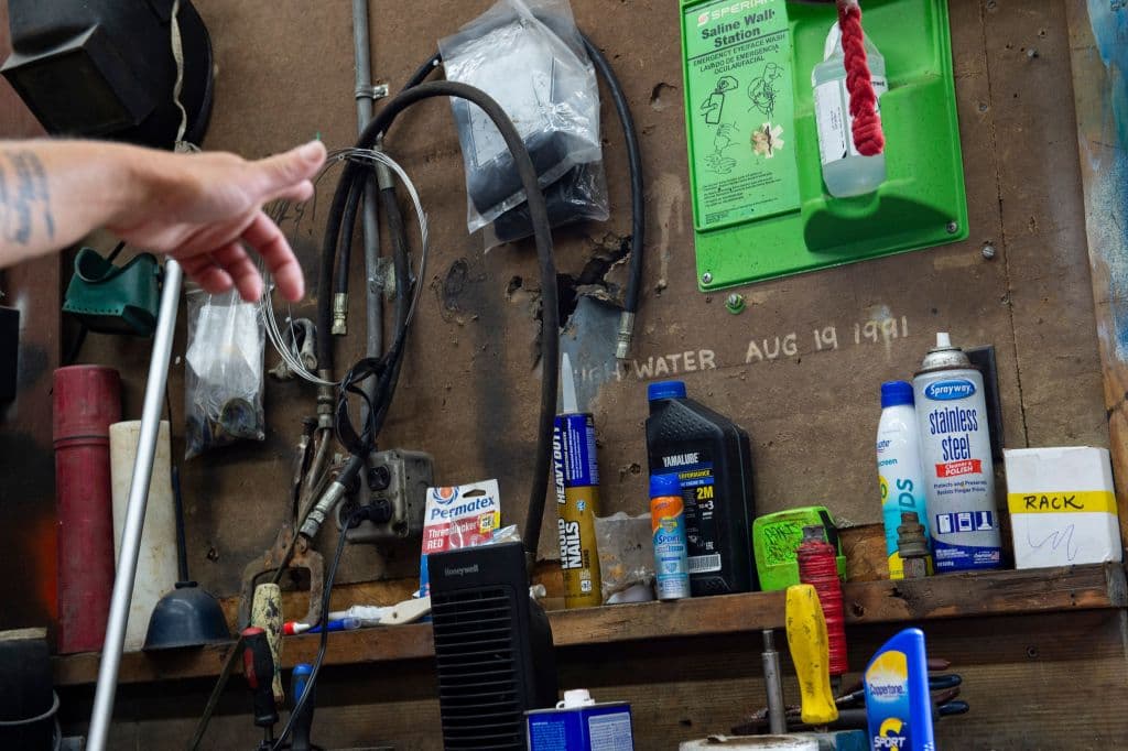 En la marina Safe Harbor, la estibadora Jessica Iacobucci señala un punto en la pared de la oficina del lugar hasta donde llegó el agua tras el impacto del huracán Bob hace 30 años.