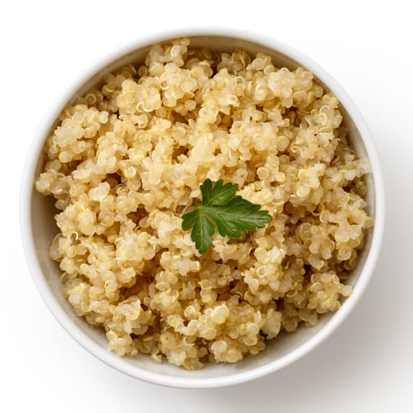 Cooked quinoa in white ceramic bowl isolated on white from above with green parsley.
