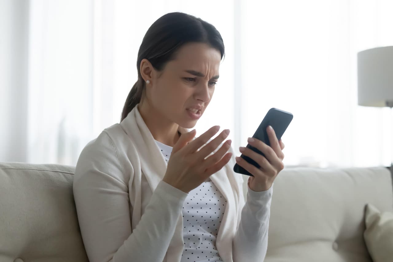 Unhappy young woman frustrated by cellphone problem
