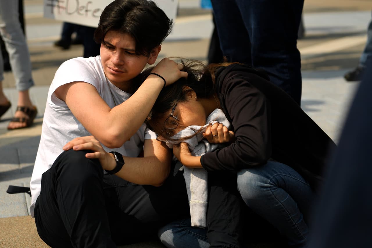 DENVER, CO - SEPTEMBER 5: 9th graders at DSST Cole 16 year old Julian Cadello comforts 15 year old Nancy Flores during the speeches as students, immigrants and Impacted individuals marched to Tivoli Quad on Auraria Campus to defend the Deferred Action for Childhood Arrivals (DACA) program during a city wide walkout and rally at Auraria Campus downtown Denver, CO. (Photo by Joe Amon/The Denver Post via Getty Images)