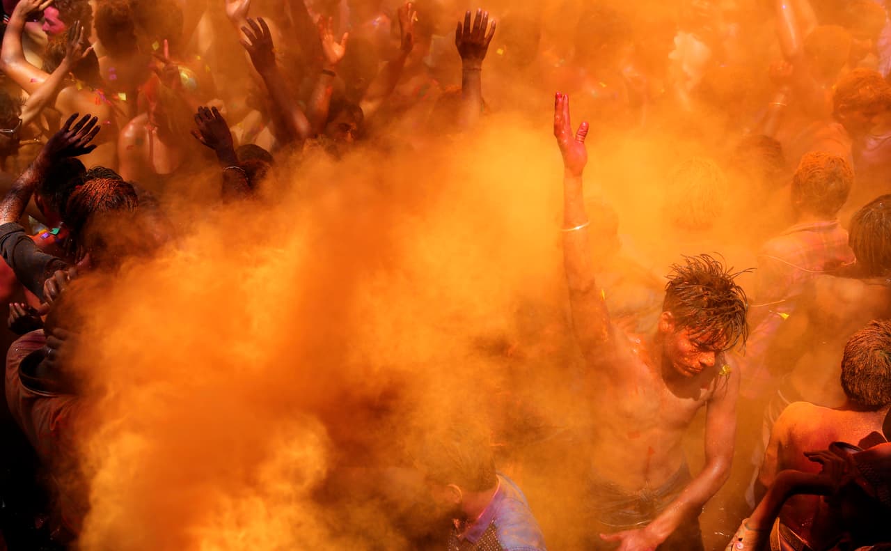 <b>Baño de color en India. </b>Bailarines policromados celebran el festival Holi en Prayagraj, India. Esta festividad anual marca el fin del invierno y la llegada de la primavera, y las personas armadas con globos de agua coloreada y polvo de múltiples tonos juegan a colorear sus cuerpos. 22 de marzo de 2019.