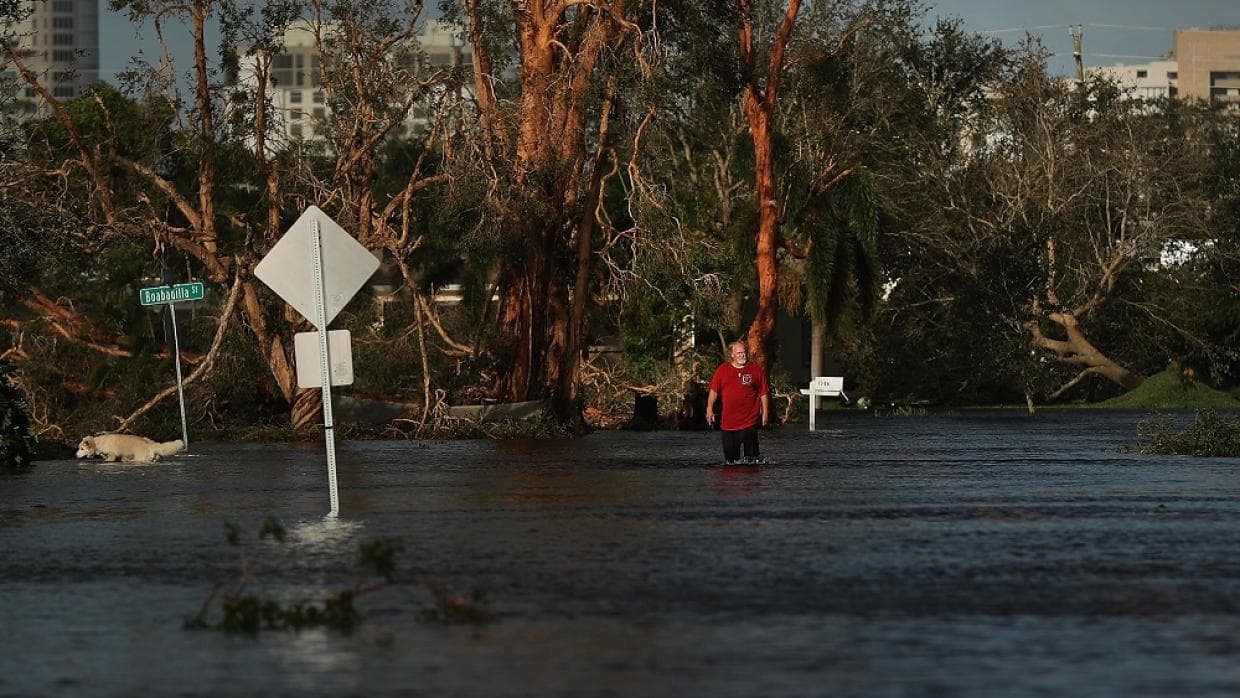 A man walks through flood waters in Naples, Florida.