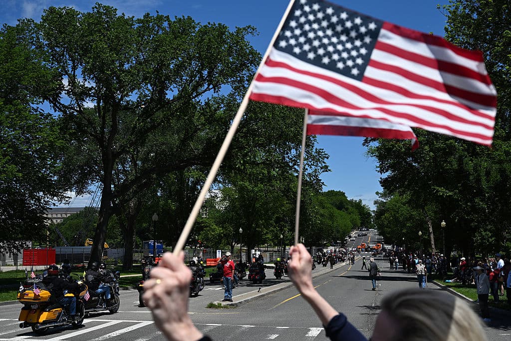 Voluntarios repartieron banderas y cintas negras en memoria de 83,000 combatientes desaparecidos en acción.