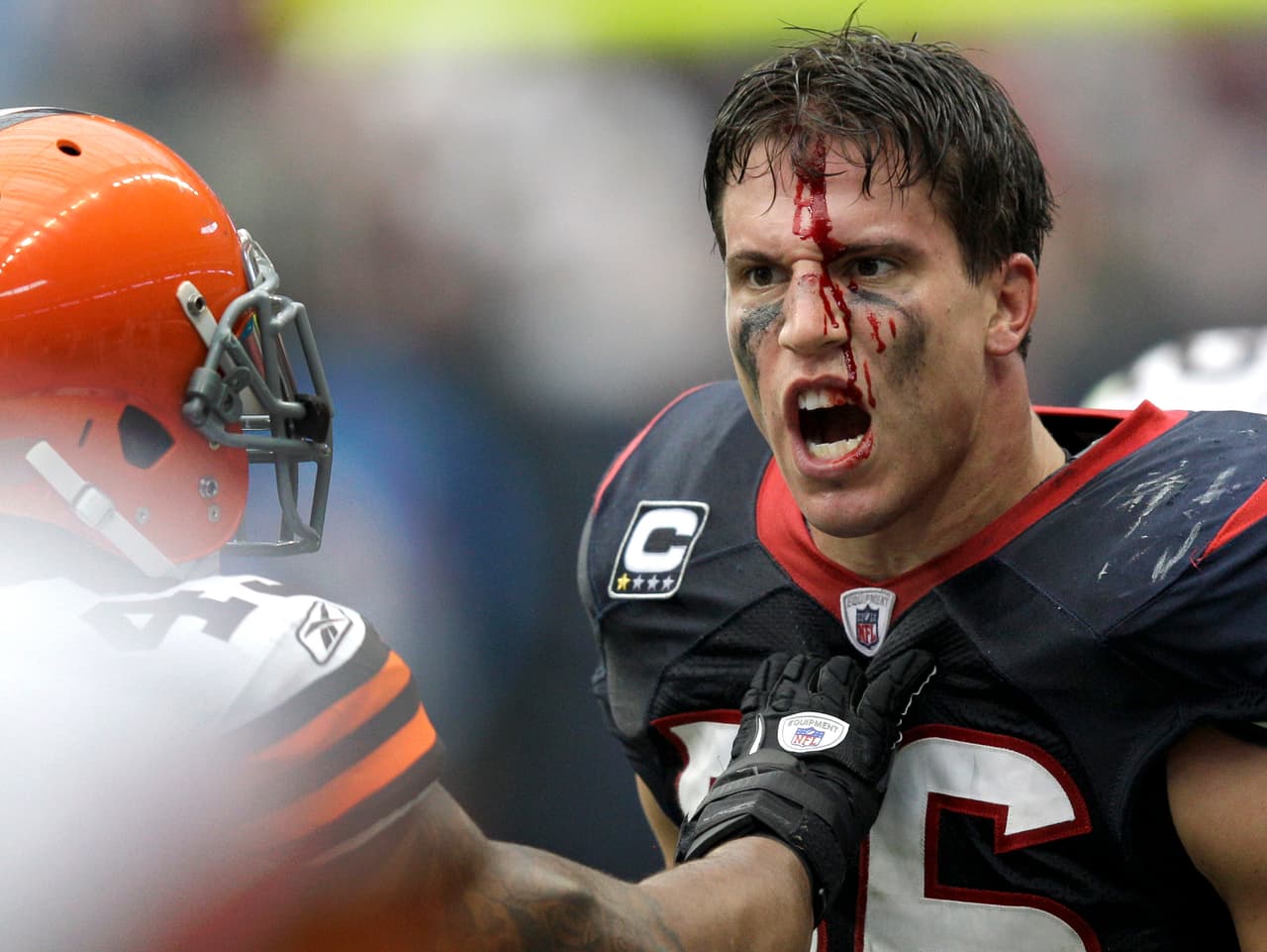 Houston Texans inside linebacker Brian Cushing, right, reacts after being hit by Cleveland Browns' Shawn Lauvao, as T.J. Ward, left, holds him off, in the second quarter of an NFL football game on Sunday, Nov. 6, 2011, in Houston. Lauvao was called for a personal foul on the play. (AP Photo/David J. Phillip)
