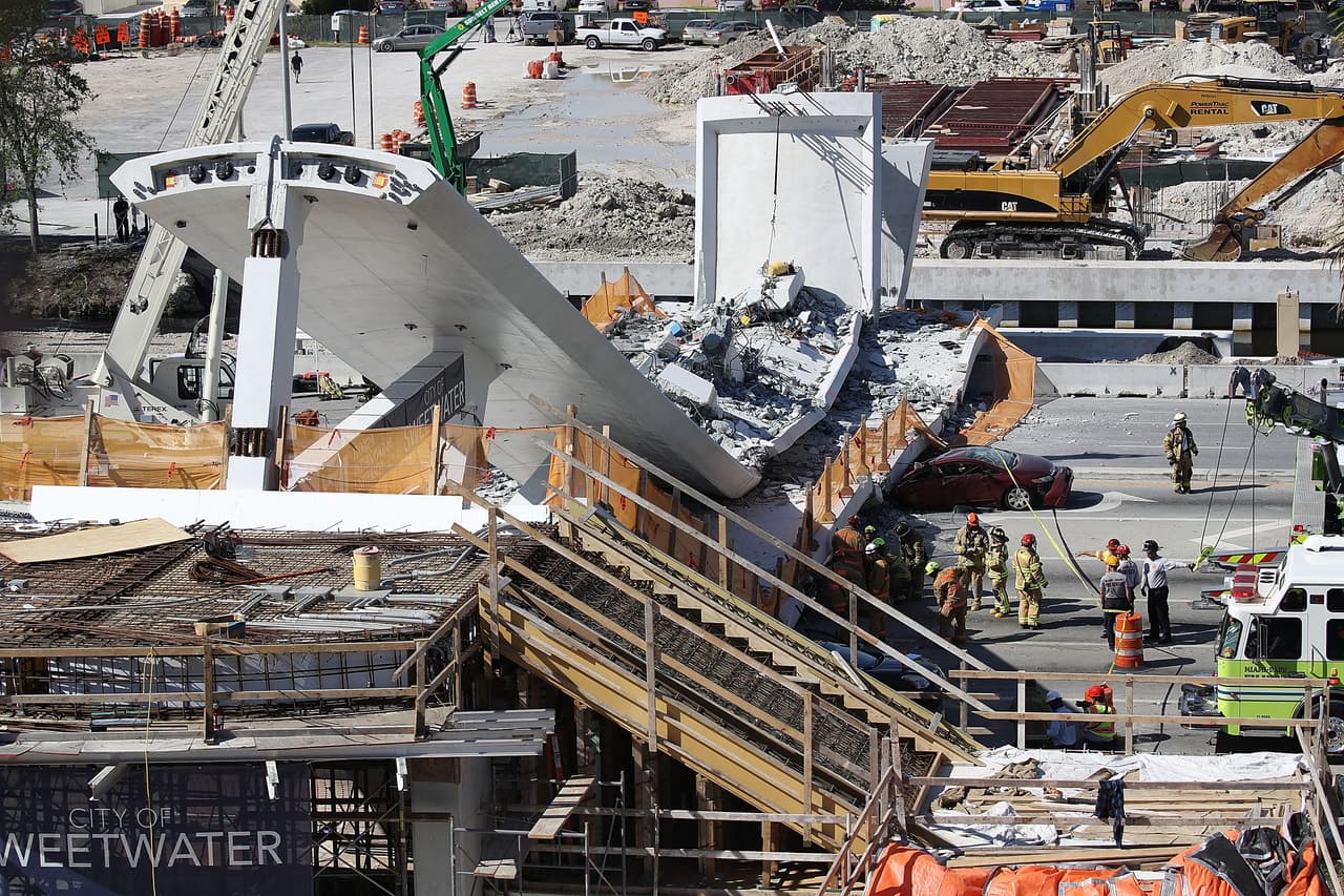 MIAMI, FL - MARCH 15: Miami-Dade Fire Rescue Department personel and other rescue units work at the scene where a pedestrian bridge collapsed a few days after it was built over southwest 8th street allowing people to bypass the busy street to reach Florida International University on March 15, 2018 in Miami, Florida. Reports indicate that there are an unknown number of fatalities as a result of the collapse, which crushed at least five cars. (Photo by Joe Raedle/Getty Images)