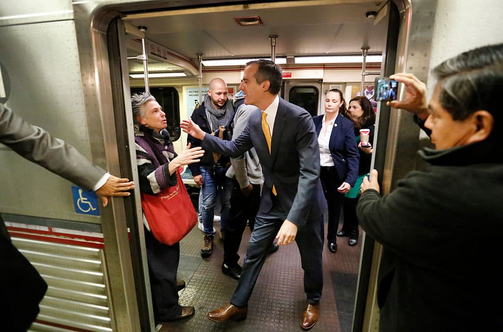 LOS ANGELES, CA - DECEMBER 6: Los Angeles Mayor Eric Garcetti says good bye to commuter Susan Rorke, left, who exclaimed "You made my day, you made my day" as he visited with passengers aboard the Metro Red Line that he boarded at the Universal City / Studio City Station on Tuesday morning December 6, 2016 in Los Angeles, California. Garcetti rode the metro in response to a warning about a bomb plot against Universal City station. An overseas tip about an imminent bombing of the Metro Red Line's Universal City station has forced federal and local law enforcement in Los Angeles to swiftly ramp up security across its sprawling transit system, authorities said Monday. An anonymous man warned of a potential attack on Tuesday and provided the information on a tip line abroad, according to Deidre Fike, the assistant director in charge of the FBI's office in Los Angeles. (Photo by Al Seib - Pool/Getty Images)