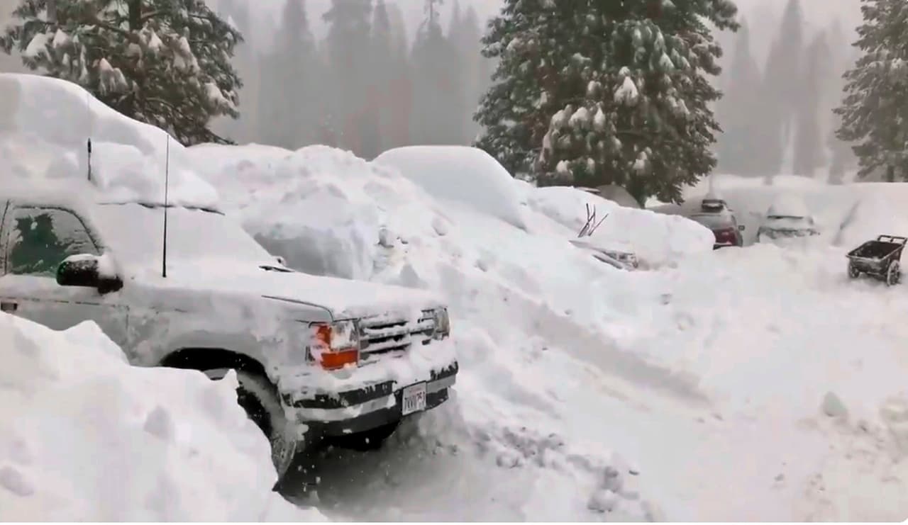 This Tuesday, Feb. 5, 2019 photo from video by Joel Keeler shows vehicles buried in the parking lot of the snowed-in Montecito Sequoia Lodge in Kings Canyon National Park in California's Sierra Nevada. More than 120 visitors and staff who became snowbound in the Sierra Nevada resort for five days have been freed. The U.S. Forest Service says snow trapped the guests and staff at the lodge starting Sunday following a storm. They couldn't get out until Thursday night, Feb. 7, 2019. (Joel Keeler via AP)
