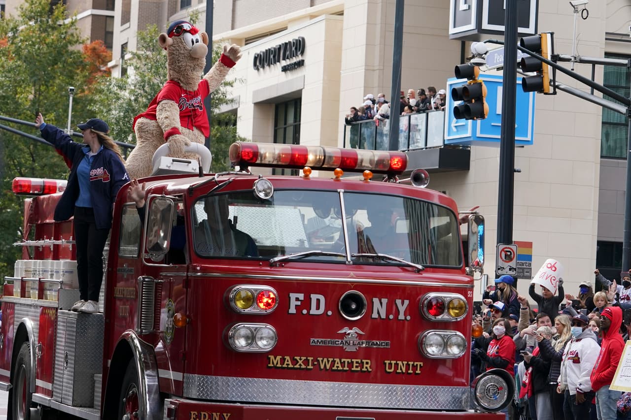The Atlanta Braves mascot Blooper rides oin a fire truck during a victory parade for the Atlanta Braves organization, Friday, Nov. 5, 2021, in Atlanta. The Braves beat the Houston Astros 7-0 in Game 6 on Tuesday to win their first World Series baseball title in 26 years. (AP Photo/Brynn Anderson)