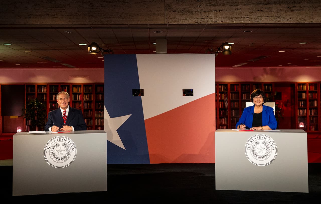 Texas Governor Greg Abbott, left, and his Democratic challenger, Lupe Valdez, smile prior to a debate at the LBJ Library in Austin, Texas, on Friday, Sept. 28, 2018. (Nick Wagner/Austin American-Statesman via AP, Pool)