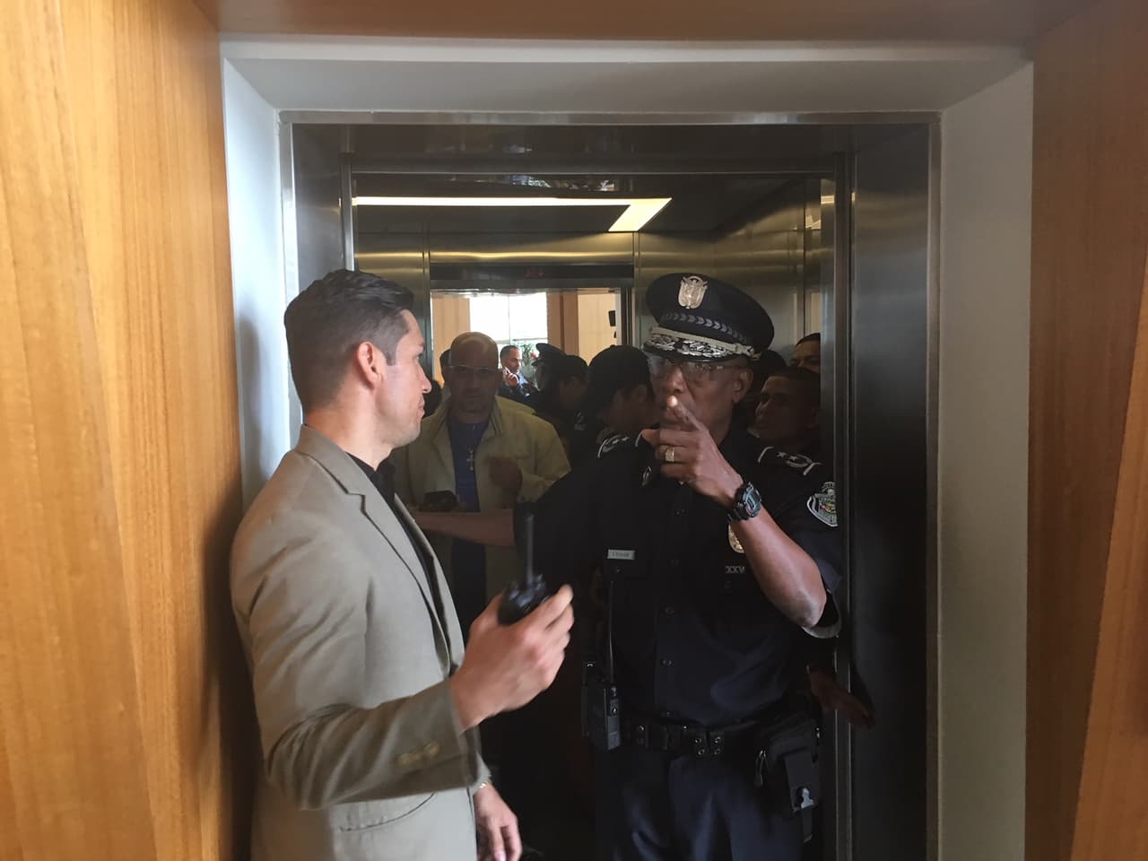 Police in the elevator at the Trump Ocean Club International Hotel & Tower on Wednesday accompany a judge looking into a dispute between the hotel's owners and the Trump management team.