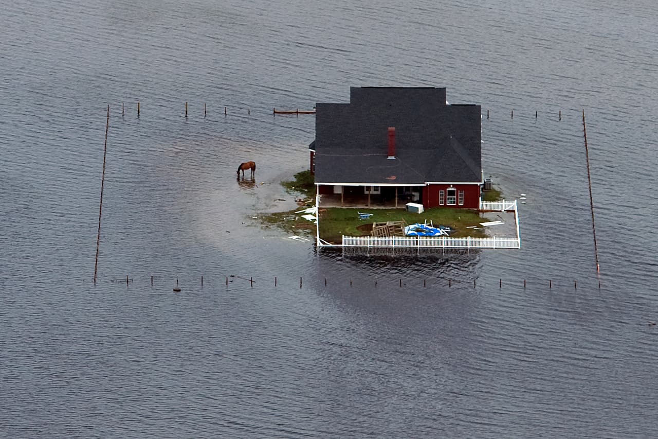 WINNIE, TX - SEPTEMBER 14: Floodwaters from Hurricane Ike surround a house September 14, 2008 near Winnie, Texas. Hurricane Ike made landfall yesterday morning at Galveston causing widespread wind and flood damage along the Texas and Louisiana coasts. (Photo by Smiley N. Pool-Pool/Getty Images)