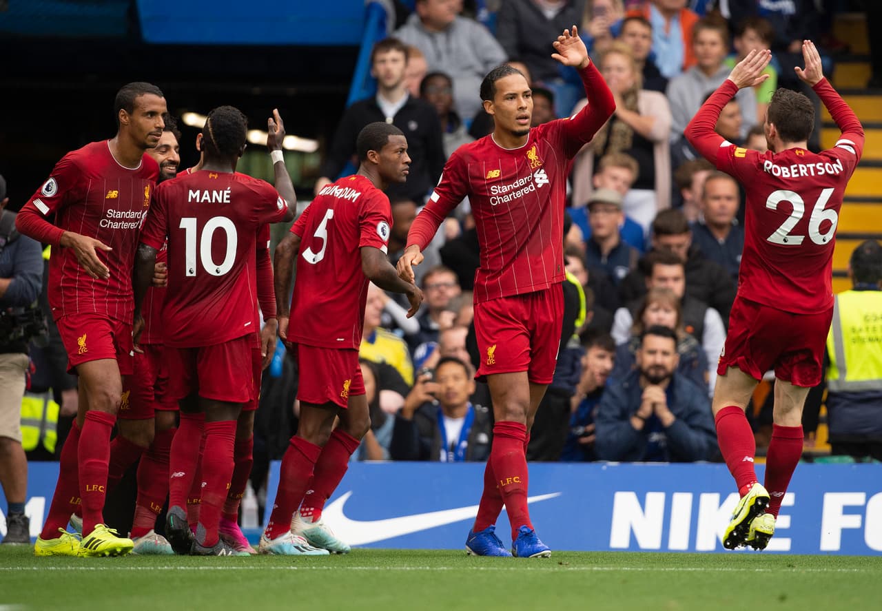 LONDON, ENGLAND - SEPTEMBER 22: Virgil van Dijk of Liverpool celebrates Andrew Robertson after Roberto Firmino's goal during the Premier League match between Chelsea FC and Liverpool FC at Stamford Bridge on September 22, 2019 in London, United Kingdom. (Photo by Visionhaus)