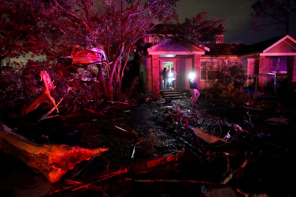 Vecinos de Arabi en el porche de una vivienda que resistió el impacto del tornado. Michelle Malasovich no escuchó el distintivo sonido parecido al de un tren de carga que muchas personas dicen que acompaña a un tornado, pero había mucho viento y su esposo le gritó que saliera de la alcoba.
