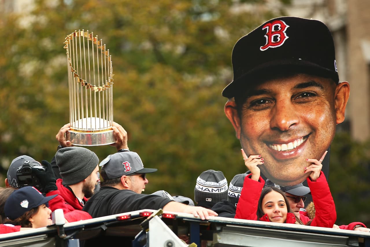 BOSTON, MA - OCTOBER 31: A girl holds a cutout of the face of Boston Red Sox Manager Alex Cora next to the World Series trophy during the 2018 World Series victory parade on October 31, 2018 in Boston, Massachusetts. (Photo by Adam Glanzman/Getty Images)