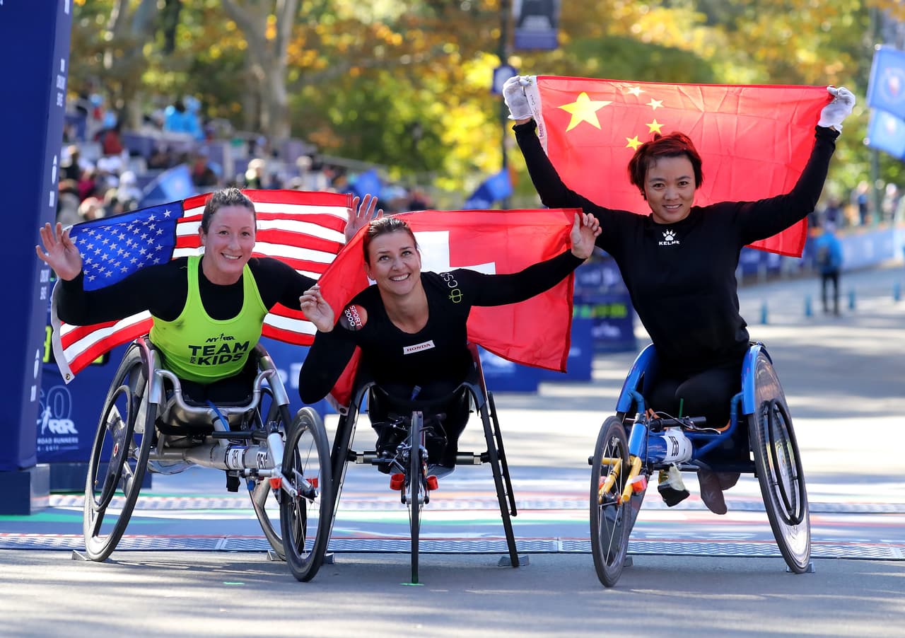 NEW YORK, NY - NOVEMBER 04: Women's wheelchair winners Tatyana McFadde of the USA in second place,Manuela Schar of Switzerland in first place and Lihong Zou of China in third place pose at the finish line after the 2018 TCS New York City Marathon on November 4, 2018 in Central Park in New York City. (Photo by Elsa/Getty Images)