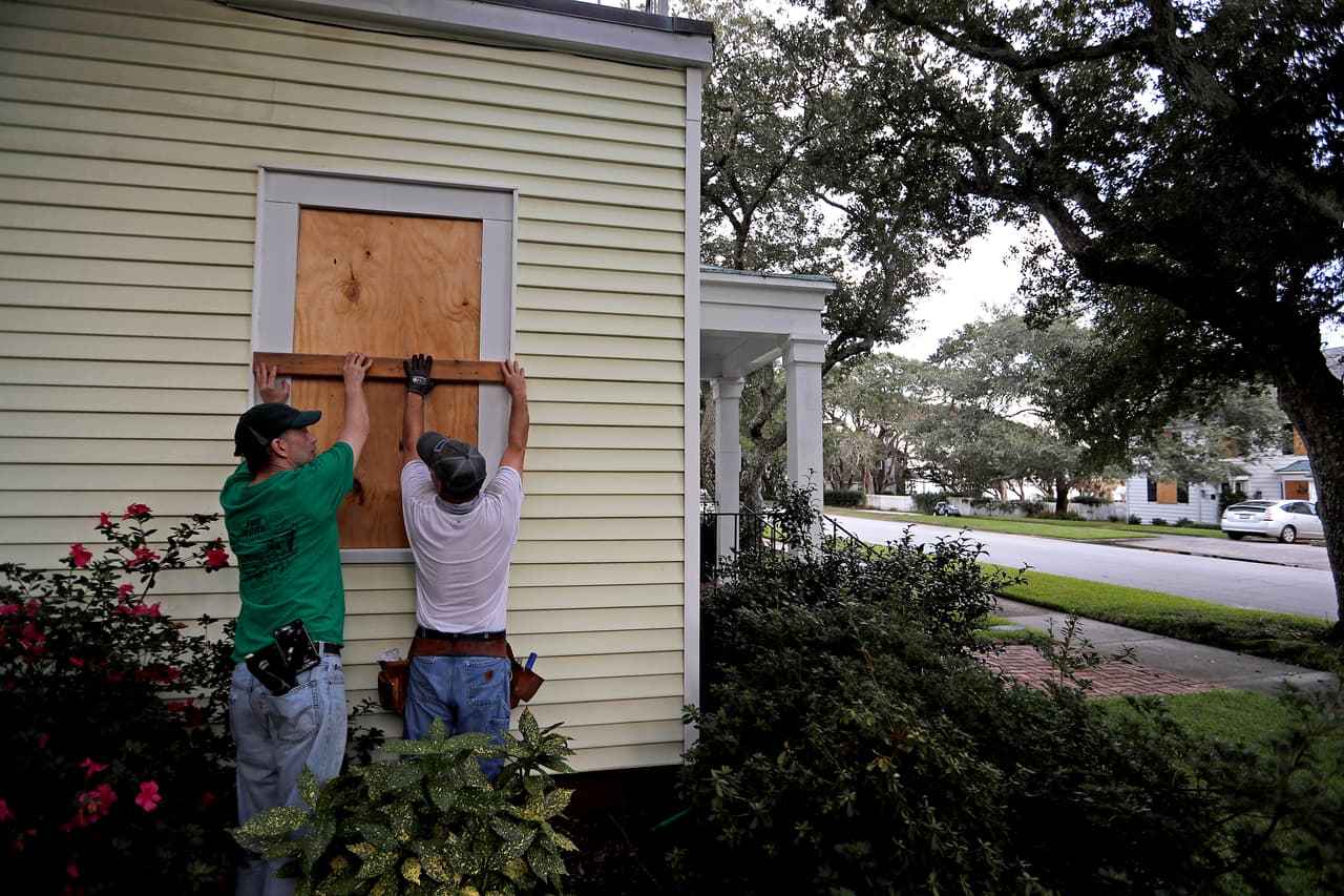 Russell Meadows, left, helps neighbor Rob Muller board up his home ahead of Hurricane Florence in Morehead City, N.C., Tuesday, Sept. 11, 2018. Florence exploded into a potentially catastrophic hurricane Monday as it closed in on North and South Carolina, carrying winds up to 140 mph (220 kph) and water that could wreak havoc over a wide stretch of the eastern United States later this week. (AP Photo/David Goldman)