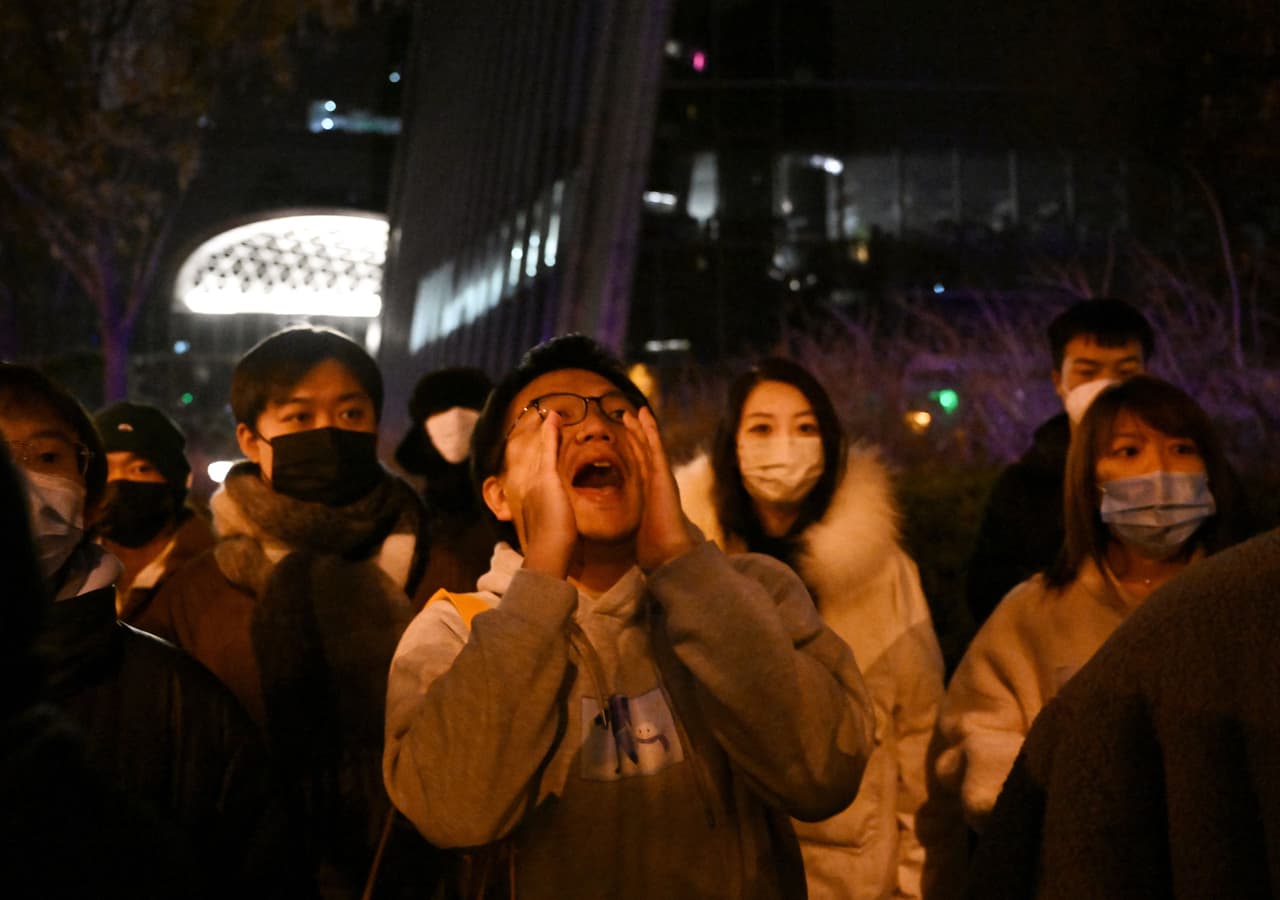 A protester shouts during a protest for the victims of a deadly fire as well as a protest against China's harsh Covid-19 restrictions in Beijing on November 28, 2022. - A deadly fire on November 24, 2022 in Urumqi, the capital of northwest China's Xinjiang region, has become a fresh catalyst for public anger, with many blaming Covid lockdowns for hampering rescue efforts, as hundreds of people took to the streets in China's major cities on November 27, 2022 to protest against the country's zero-Covid policy in a rare outpouring of public anger against the state. Authorities deny the claims. (Photo by Noel CELIS / AFP) (Photo by NOEL CELIS/AFP via Getty Images)