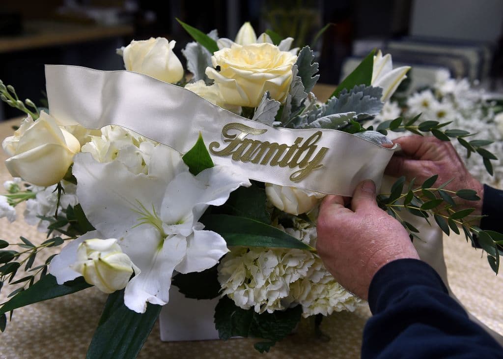 El 
<a href="https://www.univision.com/noticias/salud/medio-millon-de-muertes-coronavirus-eeuu" target="_blank">primer fallecido por la enfermedad en EE UU</a> fue anunciado hace un año, el 29 de febrero de 2020. En la imagen, un florista acomoda un arreglo en memoria de una víctima en Arlington (Virginia), poco antes del discurso de 
<a href="https://www.univision.com/temas/joe-biden">Biden</a>.