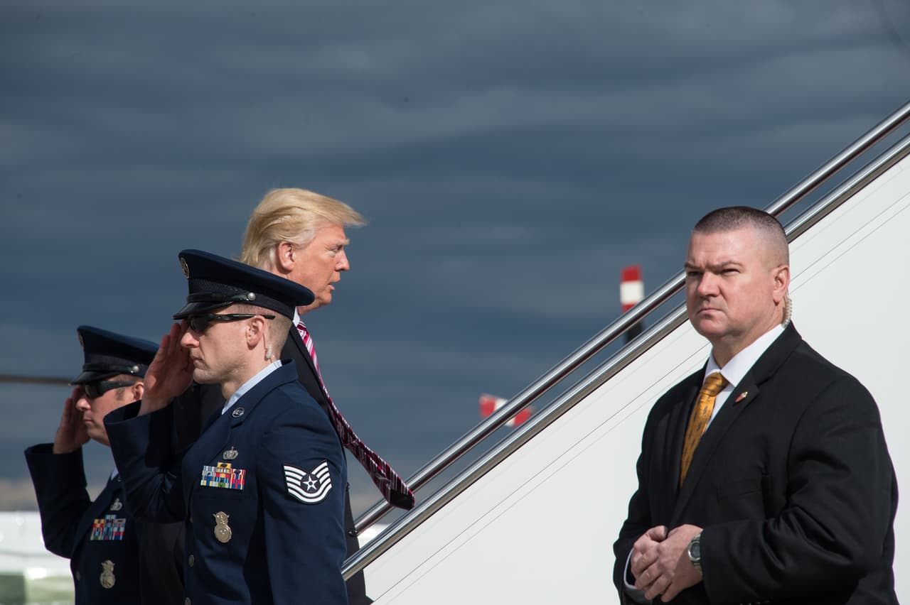 La entrada de Donald Trump a la escalera que lleva a la puerta del avión, justo después de saludar a los oficiales de la Fuerza Aérea.