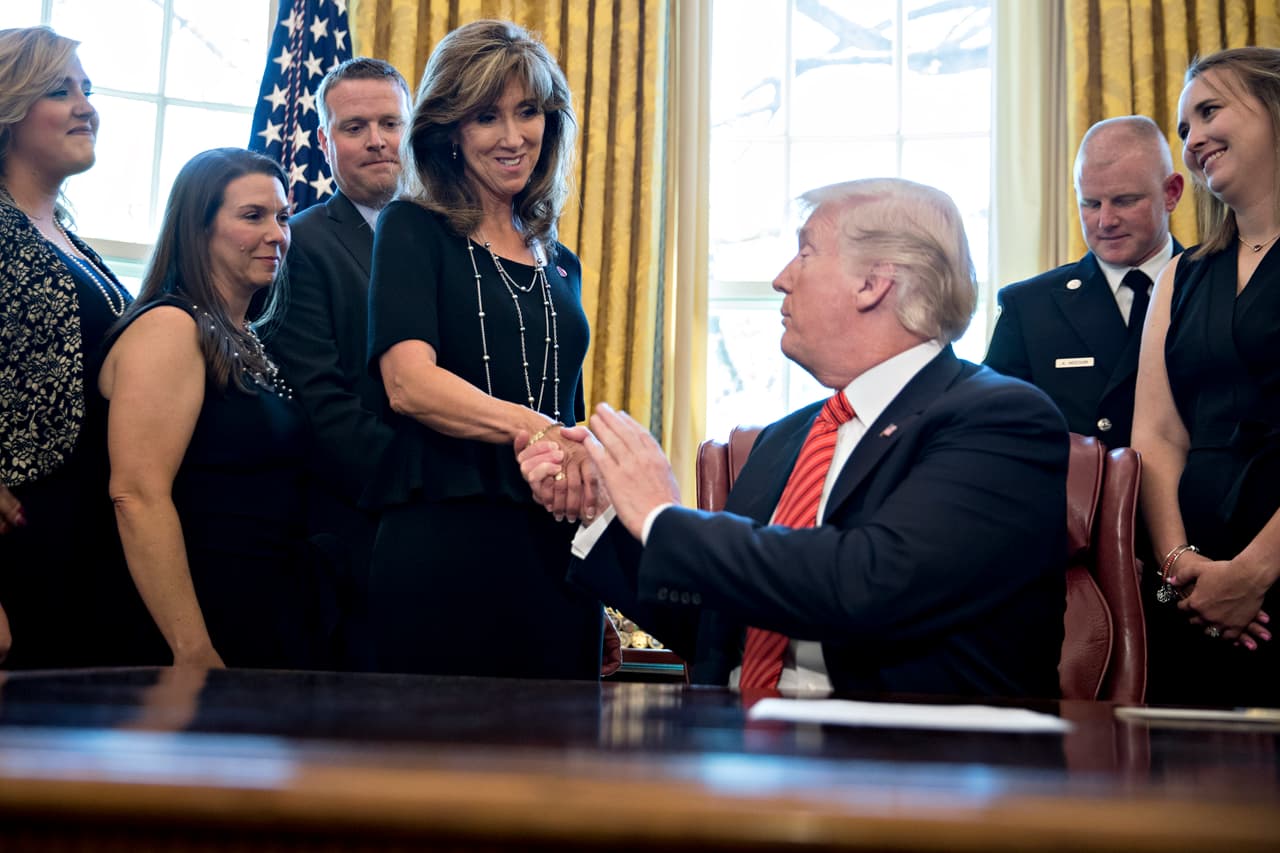 WASHINGTON, DC - MAY 01: U.S. President Donald Trump, right, shakes hands with Tammie Jo Shults, a Southwest Airlines Co. captain, while meeting with the crew and passengers of Southwest Airlines flight 1380 in the Oval Office of the White House on May 1, 2018 in Washington, D.C. An engine on Southwest's flight 1380, a Boeing Co. 737-700 from New York to Dallas, exploded forcing an emergency landing on April 17 damaging the plane and killing a passenger. (Photo by Andrew Harrer-Pool/Getty Images)