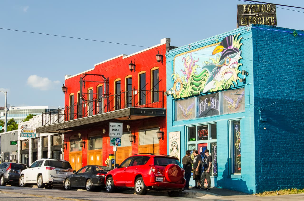 Austin, USA - July 19, 2015: Colorful tattoo and piercing store buildings on street in downtown