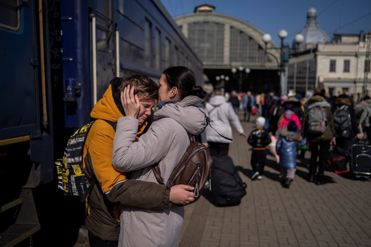 Una madre consuela a su hijo al llegar a la estación de tren de Lviv. Algunos de los recién llegados llevaban solo lo que tenían a la mano cuando aprovecharon la oportunidad de escapar del puerto de Mariupol,
<a href="https://www.univision.com/noticias/mundo/rusia-bombardea-teatro-mariupol-habia-civiles-refugio" target="_blank">sometido a los bombardeos rusos</a>.