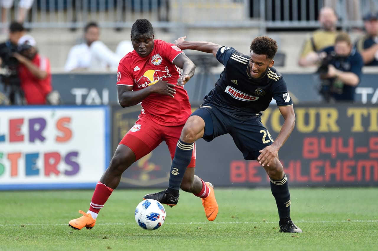 Jun 16, 2018; Philadelphia, PA, USA; New York Red Bulls forward Carlos Rivas (left) and Philadelphia Union defender Auston Trusty (26) battle for the ball during the first half at Talen Energy Stadium. Mandatory Credit: Derik Hamilton-USA TODAY Sports