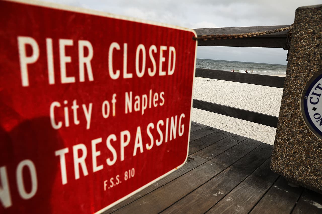 A sign announces the closure of the famous pier at Naples beach, before the arrival of Hurricane Irma.