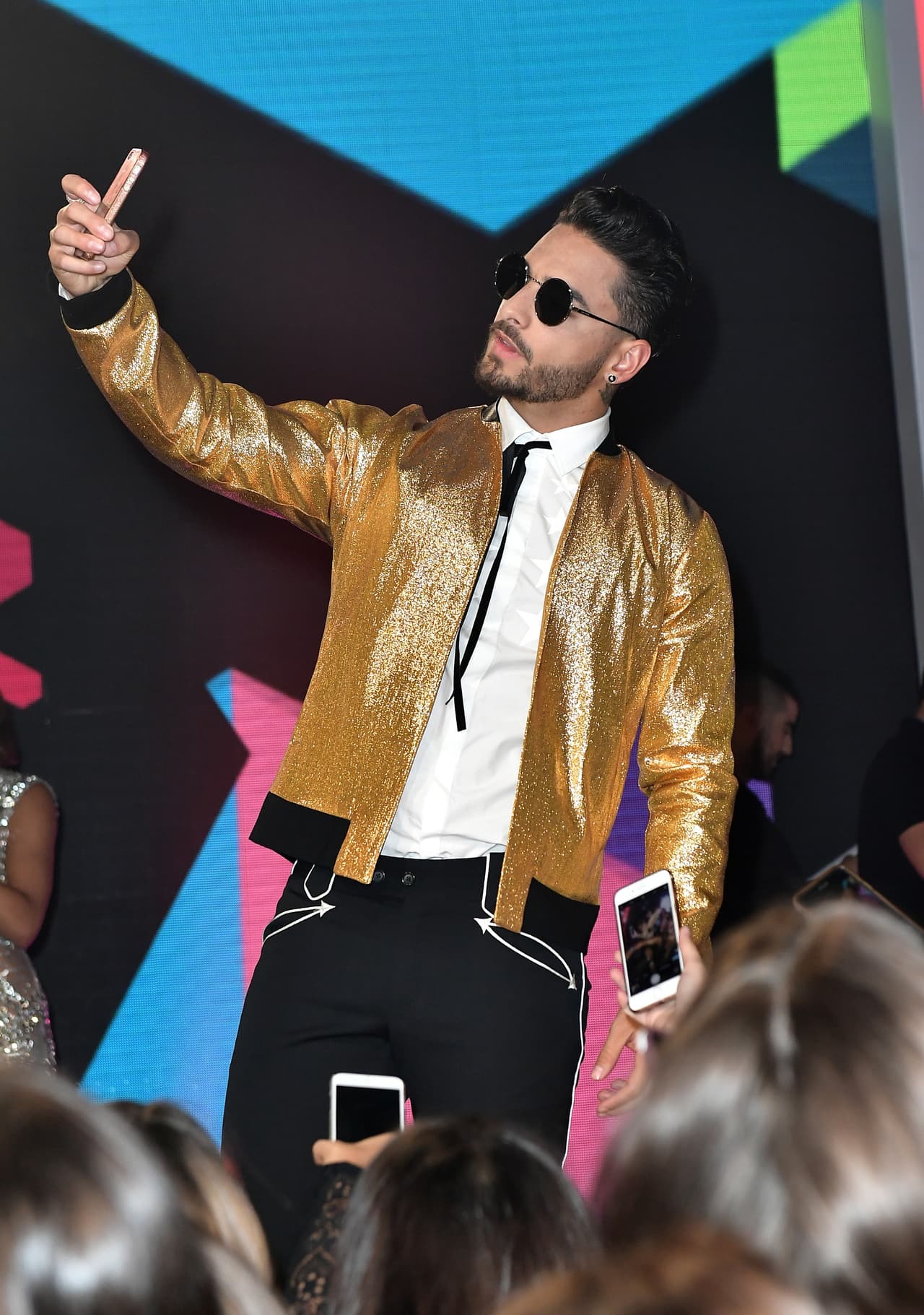 El cantante llegó al Watsco Center usando una chamarra dorada y unos jeans negros.