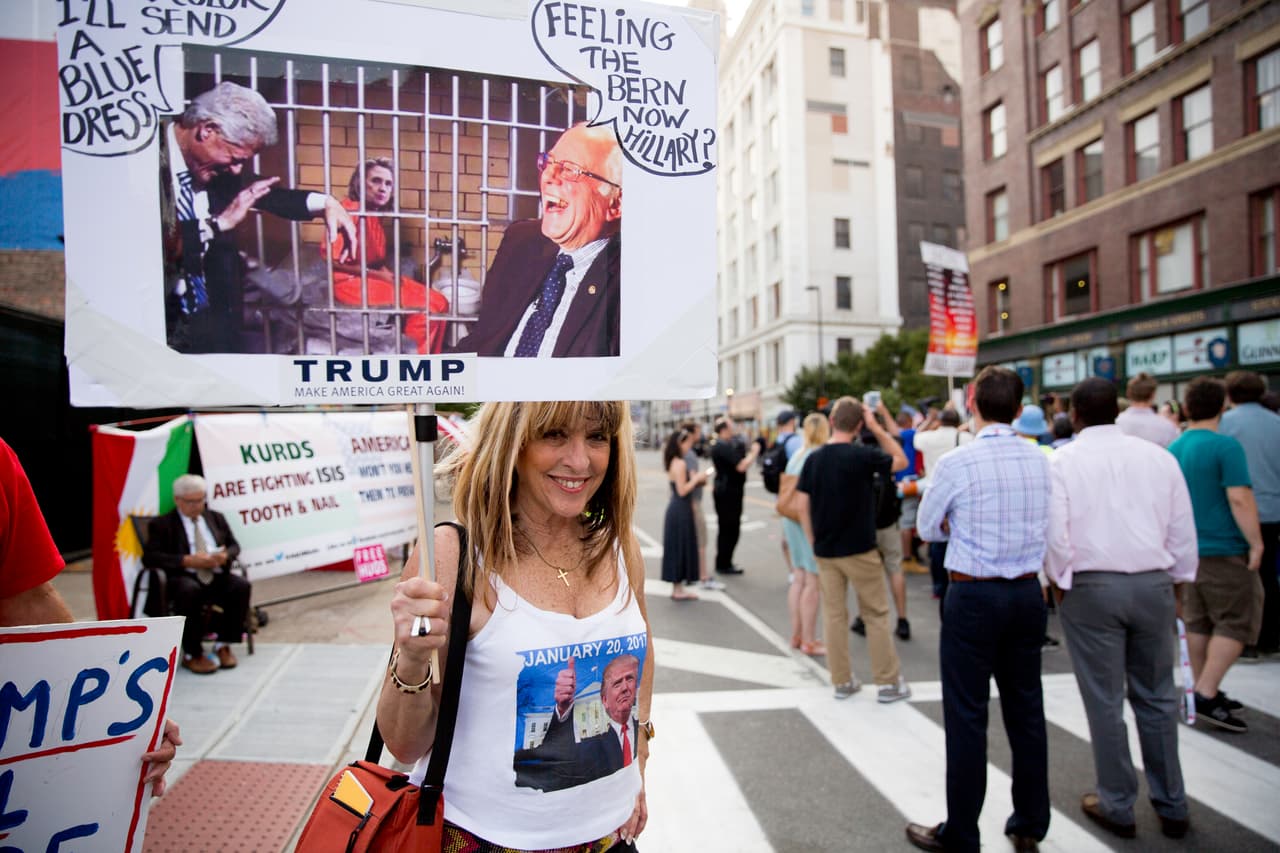 Algunos manifestantes a favor del partido republicano llevaban carteles mostrando a Clinton tras las rejas.
