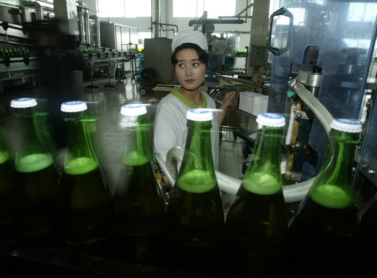 Una empleada de la fábrica estatal de cerveza en 2004, tres años después de su fundación. La producción de la planta se distribuye en 160 'salones de cerveza’ donde los habitantes de Pyongyang pueden comprar a 2.1 centavos de dólar el contenido equivalente a una lata de cerveza regular en EEUU (12 onzas), según el cambio no oficial de 8,000 won (la moneda local) por cada dólar estadounidense.