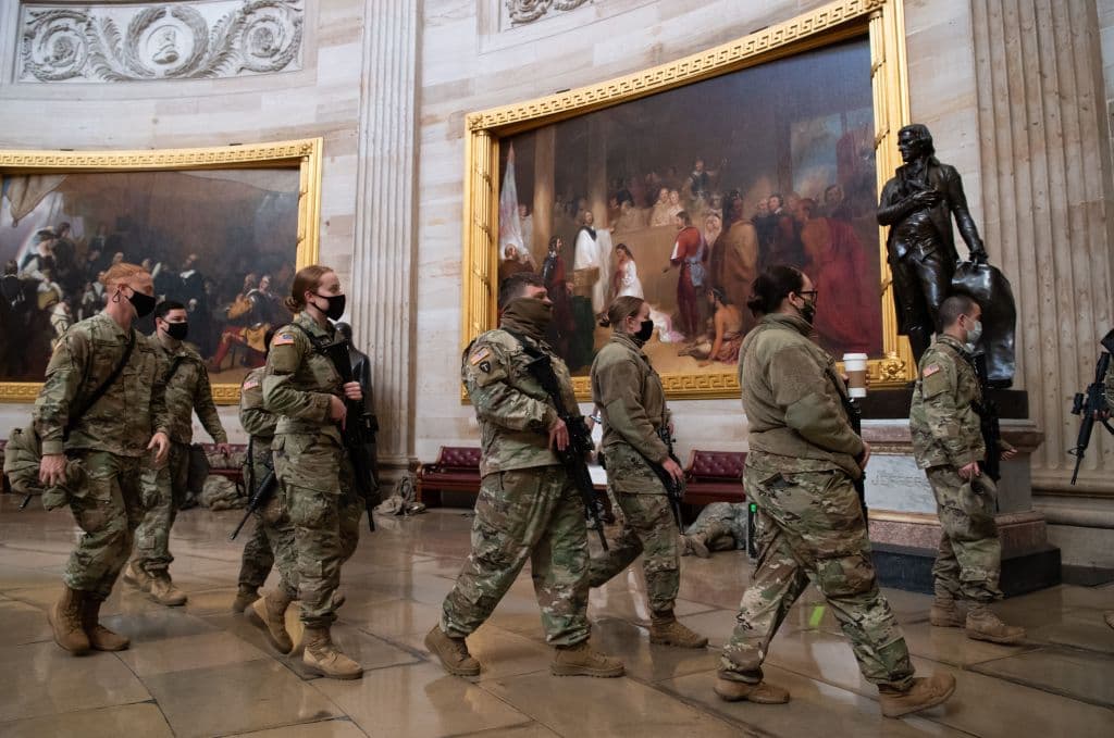 Members of the National Guard walk through the Rotunda of the US Capitol in Washington, DC, January 13, 2021, ahead of an expected House vote impeaching US President Donald Trump.