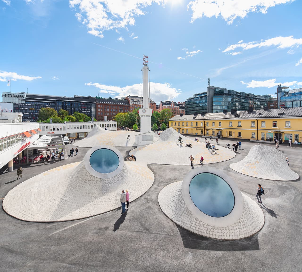 <b>Museo de Arte Amos Rex.</b> La ampliación de este centro cultural finlandés, situado en la plaza Lasipalatsi de Helsinki, fue diseñada por
<a href="https://jkmm.fi"> <u>JKMM Architects</u></a>. Un edificio subterráneo alberga los espacios de exposición y cuenta con salas de trabajo abiertas, sin pilares. Sus techos de cúpula estructural, de formas suavemente curvadas y con llamativos tragaluces, conectan el museo con la zona pública en la parte superior del complejo: la plaza. El festival World Architecture Festival (WAF) es considerado el mayor concurso de premios arquitectura del mundo.