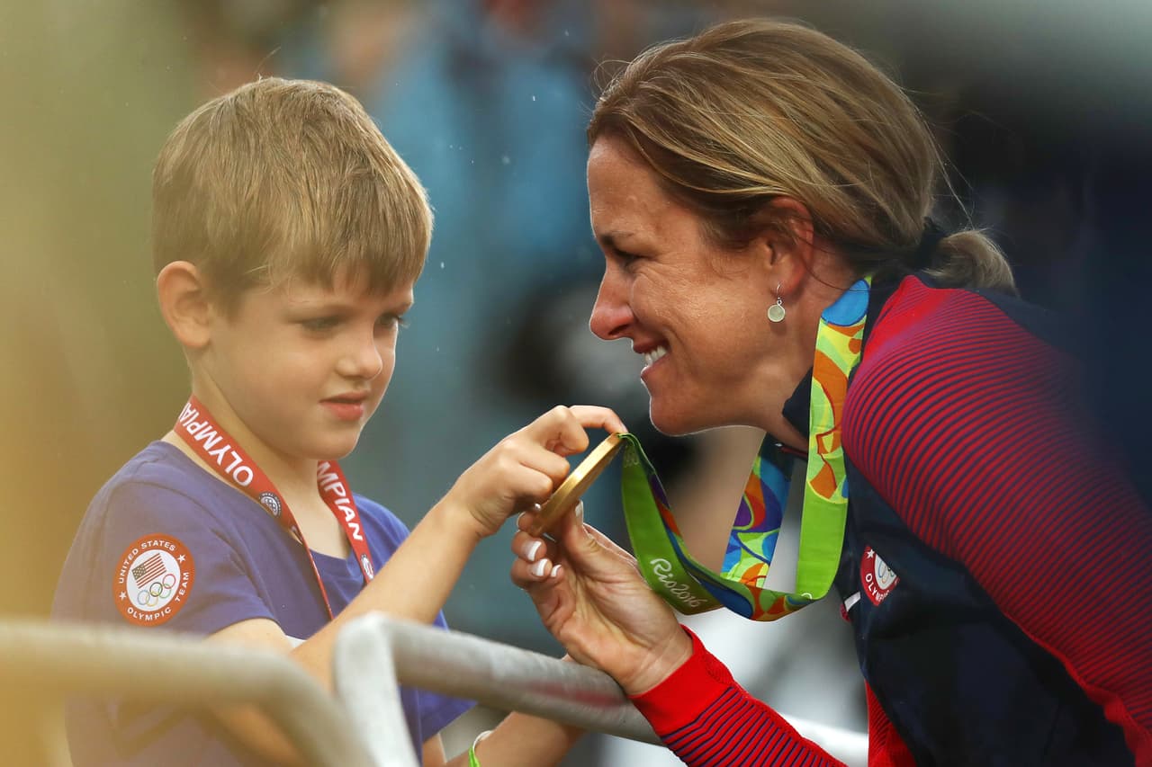 Kristin Armstrong enseñando la medalla a su hijo Lucas