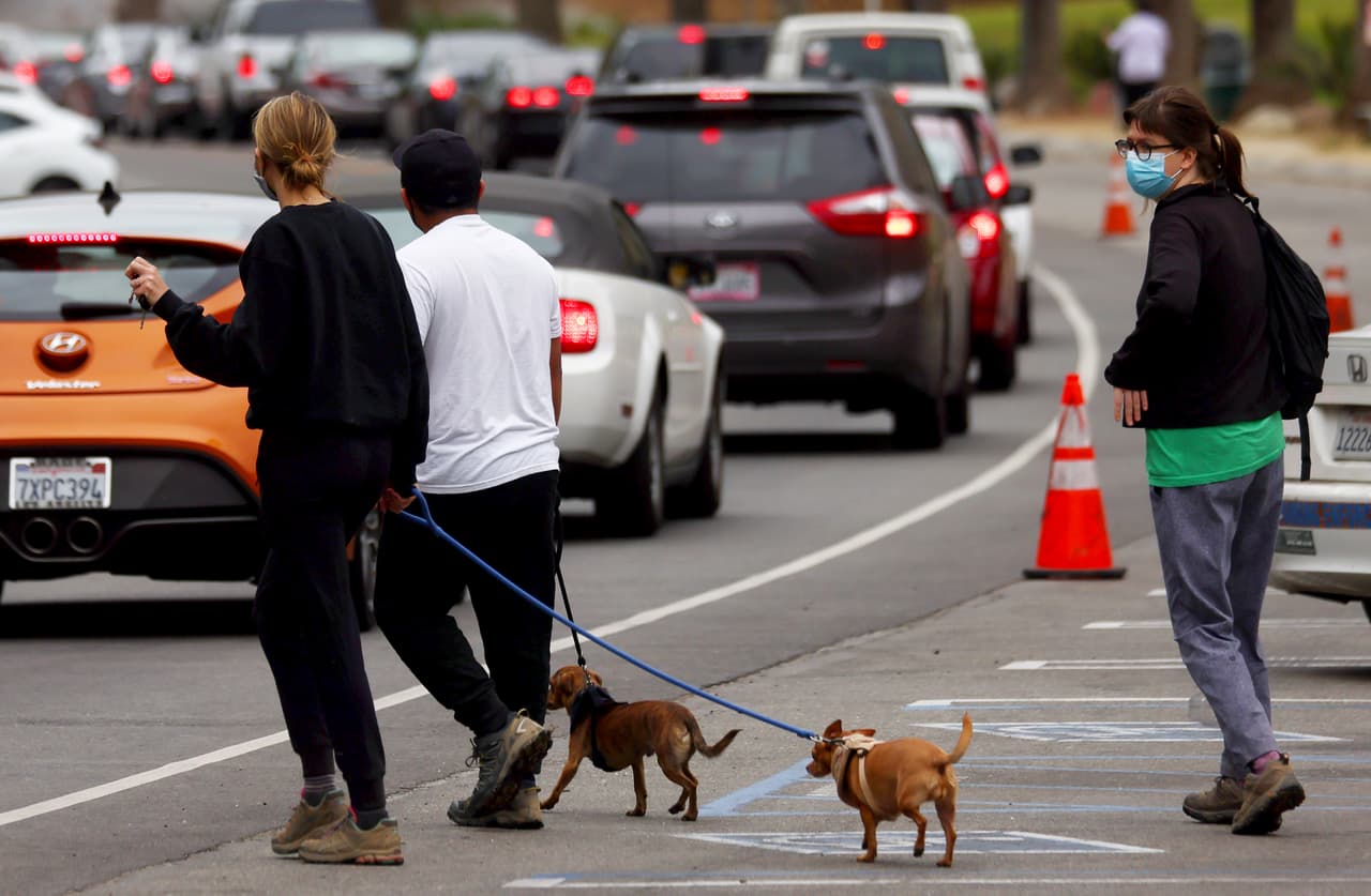 La orden de confinamiento 
<b>afecta a 33 millones de personas al sur del estado. </b>En la foto la fila de carros para hacerse la prueba de covid-19 en el estadio de los Dodgers.