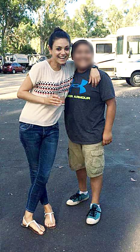 Mila muy sonriente junto a un joven seguidor.