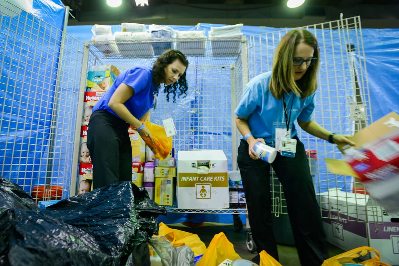 CHST(D170830R): (L-R): Lisa Jones (Child Life Supervisor) and Christine Knefley (Senior Child Life Specialist) sort through and stock diapers and other child care essentials in the Pediatrics Clinic in the Medical area of the hurricane evacuee space at the Dallas Convention Center. Children’s Health Emergency, Virtual Health, Child Life, Pharmacy, and other staff prepare the pediatric clinic in the “Megashelter” located in the Kay Bailey Hutchison Convention Center in downtown Dallas, in anticipation of the arrival of refugees from areas in Southeast Texas affected by Hurricane Harvey.