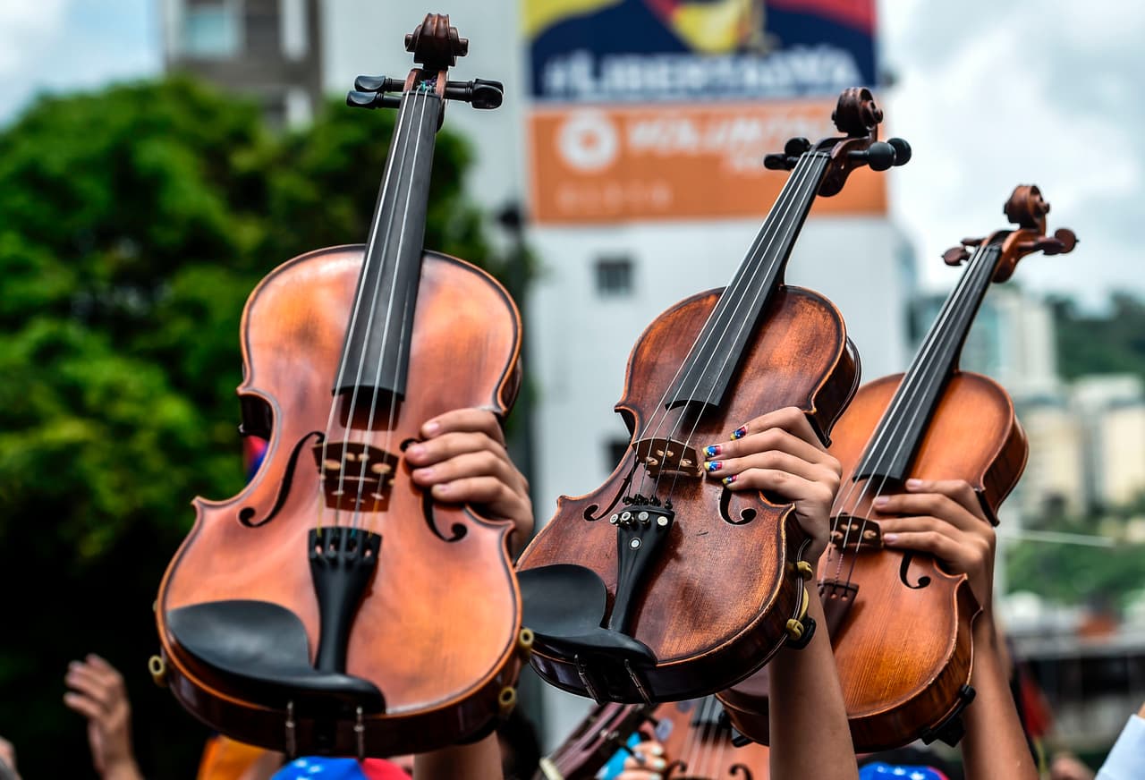 Instruments held high at an anti-government march to remember the 37 people who have died in a month-long wave of daily protests. May 7, 2017.