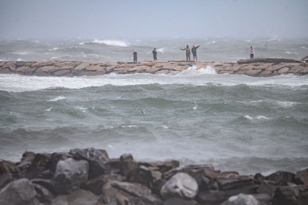 En la imagen, personas viendo las fuertes olas en Montauk, Long Island, este domingo.
