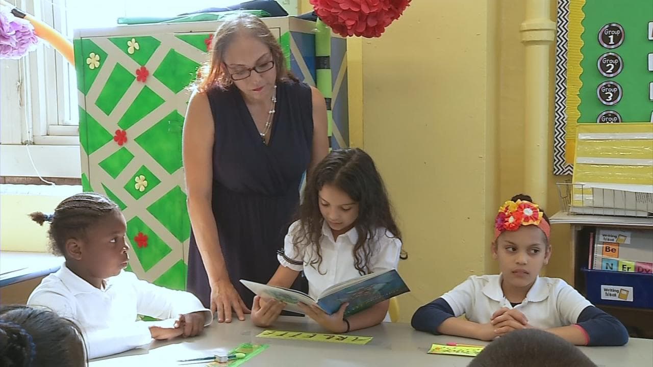 The summer heat and lack of air conditioning doesn't stop Arlette and his classmates from enjoying their classes.