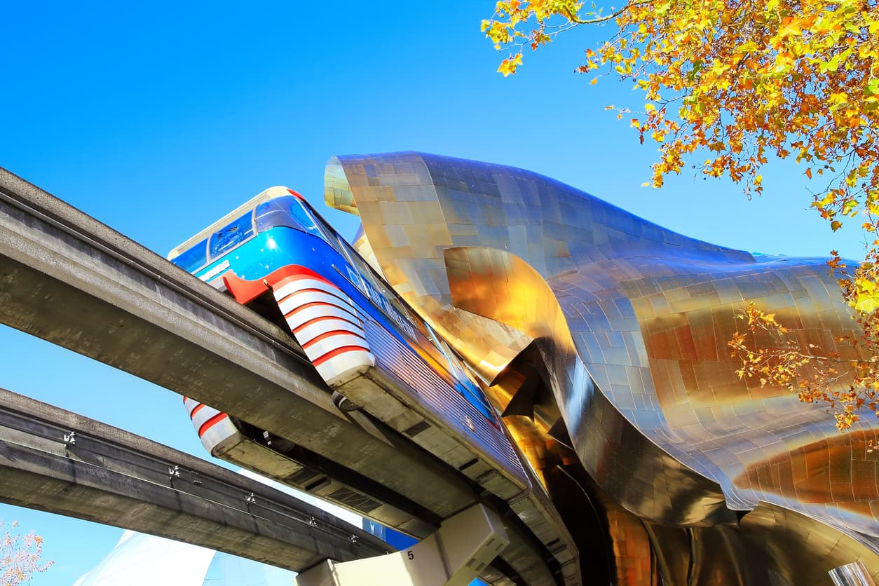 Seattle, Washington - October 25, 2016: The Monorail train passing through the ultra-modern EMP Museum on sunny fall morning