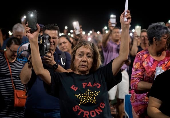 People react during a prayer vigil organized by the city, after a shooting left 20 people dead at the Cielo Vista Mall Wal-Mart in El Paso, Texas, on August 4, 2019. - The United States mourned Sunday for victims of two mass shootings that killed 29 people in less than 24 hours as debate raged over whether President Donald Trump's rhetoric was partly to blame for surging gun violence. The rampages turned innocent snippets of everyday life into nightmares of bloodshed: 20 people were shot dead while shopping at a crowded Walmart in El Paso, Texas on Saturday morning, and nine more outside a bar in a popular nightlife district in Dayton, Ohio just 13 hours later. (Photo by Mark RALSTON / AFP) (Photo credit should read MARK RALSTON/AFP/Getty Images)