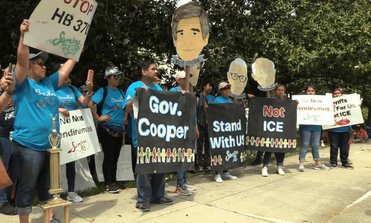 Tras la marcha de el 4 de mayo hacia la mansión del Gobernador, ya preparan la siguiente acción pública. Se trata de una vigilia propgramada para el 11 de mayo en las afueras de la mansión del gobernador donde el Colectivo NC con más de 20 organizaciones se reunirán para exigirle @Roy Cooper que no firme el proyecto de ley HB370 en caso de que avance por todos los comités de la Cámara baja en el estado.El sábado 4 de mayo, cerca de 200 hispanos marcharon hacia la mansión del Gobernador de Carolina del Norte, Roy Cooper, para pedirle que no apruebe propuestas de ley antiinmigrantes cuando lleguen a su escritorio.Las que más preocupan a la comunidad indocumentada por el momento, son la HB370 y la HB135, las cuales buscarían la cooperación entre los alguaciles de los Condados y la Agencia de Inmigración y Aduanas, ICE por sus siglas en inglés, lo cual desencadenaría de acuerdo a los activistas en un incremento en las deportaciones de inmigrantes sin documentos en Carolina del Norte.Madres, padres de familia, organizaciones y aliados de la comunidad alzaron las voces para exigir que el Gobernador Cooper los escuche.Durante la protesta, el Gobernador no hizo presencia, así como ninguna autoridad en representación del funcionario público.Esta marcha fue encabezada por la organización Siembra NC y apoyada por organizaciones aliadas como El Comité Popular Somos Raleigh y El Pueblo.“Quiero decirles a los que no pudieron venir hoy que habrá más oportunidades de apoyar y que no podemos quedarnos callados porque estas leyes afectarían a nuestras familias”, indicó en entrevista para Univision una de las manifestantes.