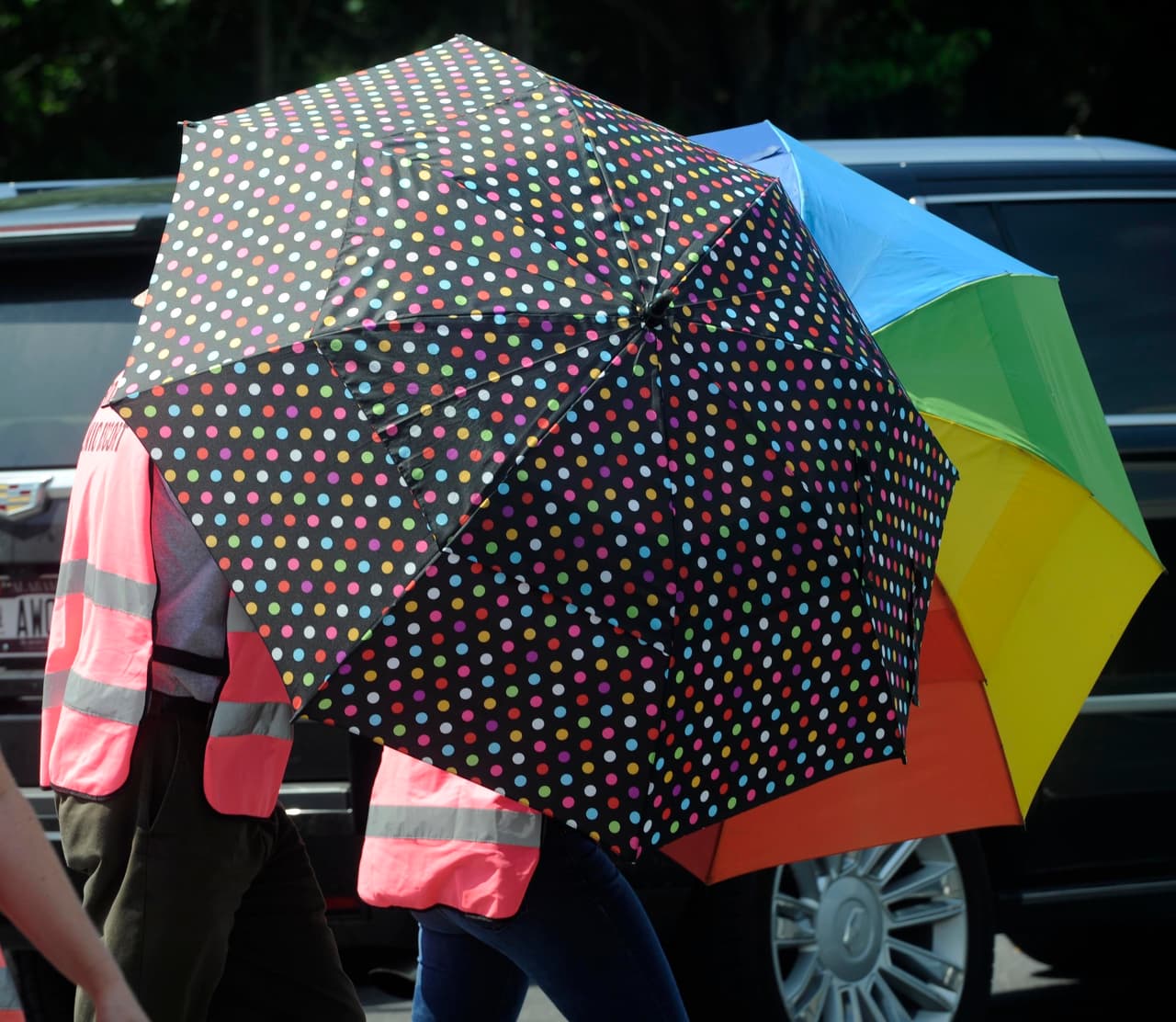 "Escorts" at abortion clinics accompany patients from their cars to the clinic doors. They use umbrellas to protect patients’ identities, while protesters broadcast their arrival live via Facebook. In the picture, escorts accompany patients at the Huntsville clinic in May.