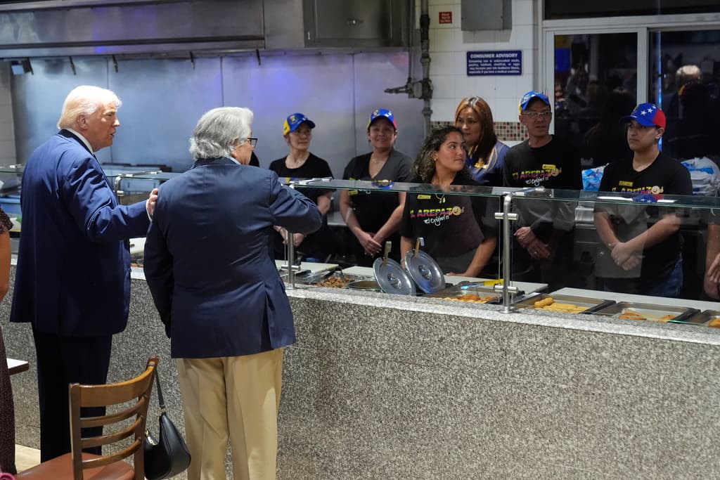 El presidente Donald Trump se acerca al mostrador de El Arepazo a ver las opciones de arepas.