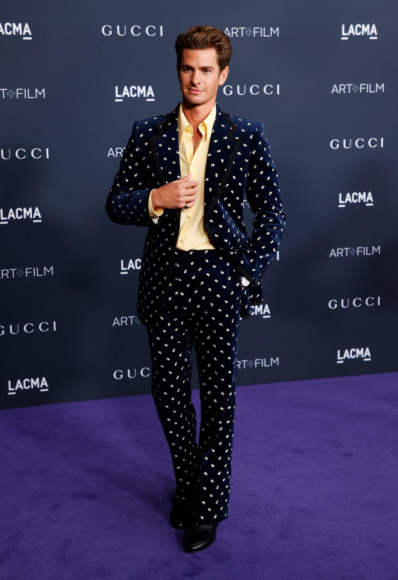 Andrew Garfield se decantó por un estilismo de los años 70. El actor de 'The Amazing Spider-Man' posó con un traje Gucci de terciopelo en color azul marino que combinó con una camisa amarilla del mismo tono que los lunares en el coordinado.