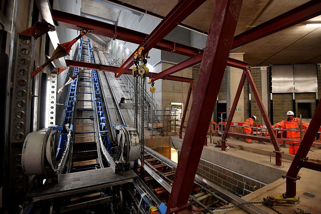 Construction workers instal escalators inside a Crossrail train station at Tottenham Court Road in central London on November 16, 2016. The Crossrail project, which is expected to be completed in 2018, will link Berkshire, west of London with Essex, east of London. / AFP / BEN STANSALL (Photo credit should read BEN STANSALL/AFP/Getty Images)